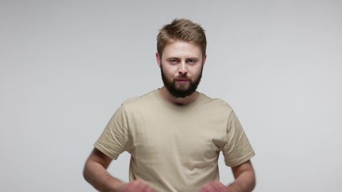 Cunning bearded man with tricky face thinking artful prank, evil sly revenge plan, rubbing palms having sneaky idea cheats, scheming and conspiring. indoor studio shot isolated on gray background