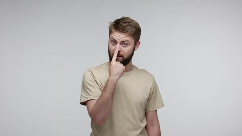 You lie to me! Bearded man suspecting falsehood, touching nose doing liar gesture and pointing at camera, angry about deception, distrustful communication. studio shot isolated on gray background
