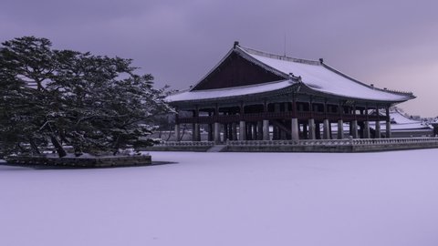 Time lapse4k. korea winter.  snow storm and Gyeonghoeru Pavilion at Gyeongbokgung Palace in Seoul, South Korea. (Gyeonghoeru Pavilion on a sign.)