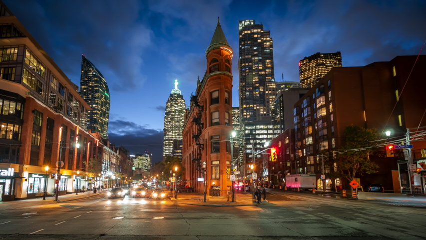 Toronto, Canada, timelapse view of historical landmark Gooderham Flatiron building and traffic in Downtown Toronto at dusk.