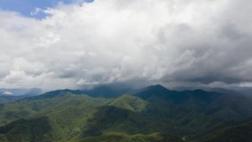 4K Time lapse of mountains on rainy day and clouds moving along the rain, stormy cloud, rainy season forest landscape background