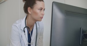 doctor face looking at office monitor . Close-up of woman thinking about results, patients, work. Portrait of female looking laptop at home. Over display camera shot. 4k raw video footage slow motion