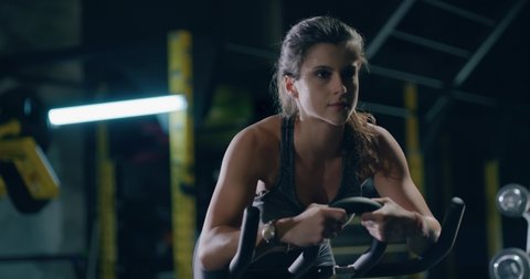 Young Fit Woman Exercising On Stationary Bike Closeup At The Gym Active Lifestyle Sportswear Concentration Strength Endurance Health Focused Fitness Concept 4k