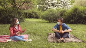 During the coronavirus lockdown crisis, they seat and discuss in the garden. Relations, friendship and love concept. Social distancing and virus protection. - Powered by Shutterstock - Get 15% off with code: PIKWIZARD15