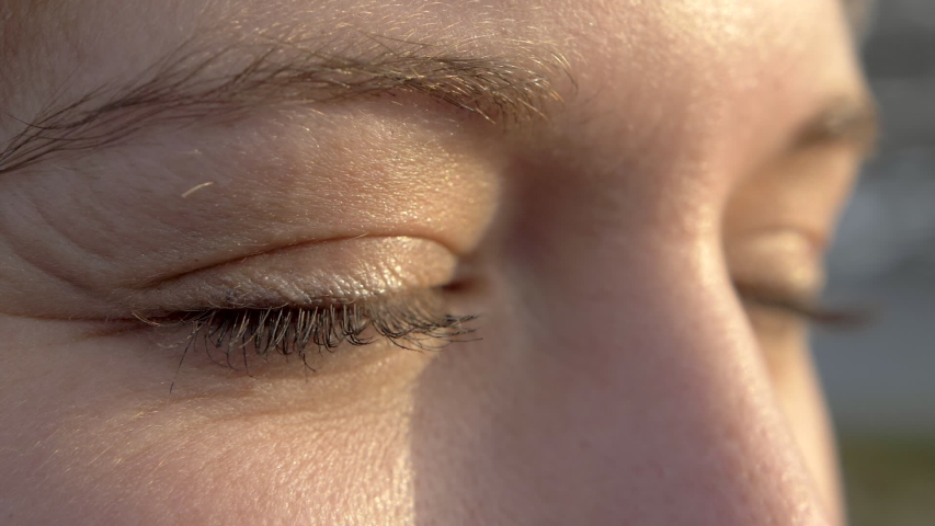 Macro Close Up of a Woman Opening Her Eyes with Nice Sunset Lighting Royalty-Free Stock Footage #1055434802