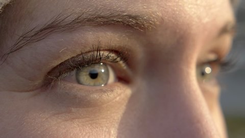 Macro Close Up of a Woman Opening Her Eyes with Nice Sunset Lighting