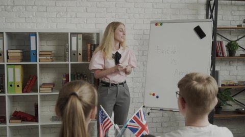 Teacher explaining differences between American and British writing on whiteboard English language school