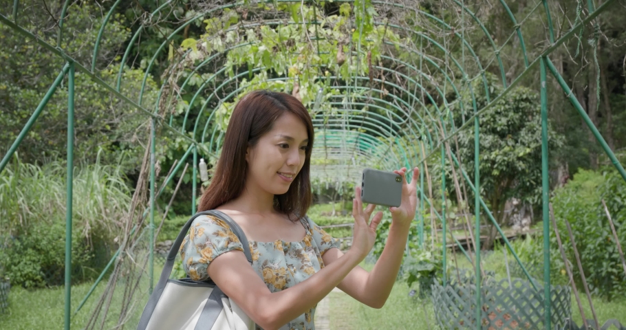 Woman woman to take photo in garden