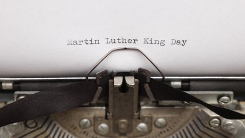 Typing a phrase Martin Luther King Day on a vintage typewriter close-up. concept of festive banner for national holiday