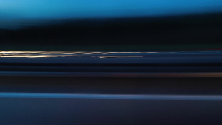 Abstract side view of car light trails moving fast at night time lapse Royalty-Free Stock Footage #1055450078