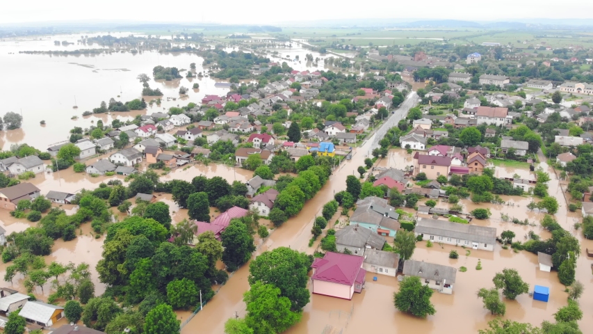 Aerial View from above on the flooded houses and the city. Flood after floods from the mountains. The houses are flooded with dirty water of the flooded river Royalty-Free Stock Footage #1055450348
