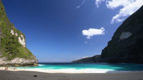 Azure beach with rocky mountains and clear water of Indian ocean at sunny day / A view of a cliff in Bali Indonesia / Bali, Indonesia