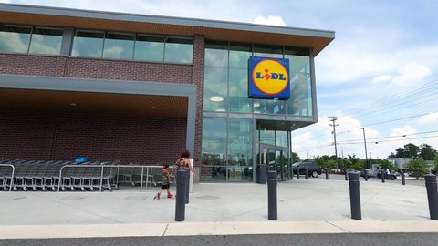 Lilburn, Ga  USA - 07 05 20: People wearing masks entering and exiting LIDL in Lilburn, Ga during the covid-19 pandemic