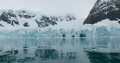 MS PAN Snow covered mountains and glacier surrounding bay / Sanaviron Peninsula, Antarctica
