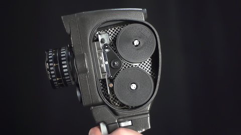 old movie camera with spinning film inside