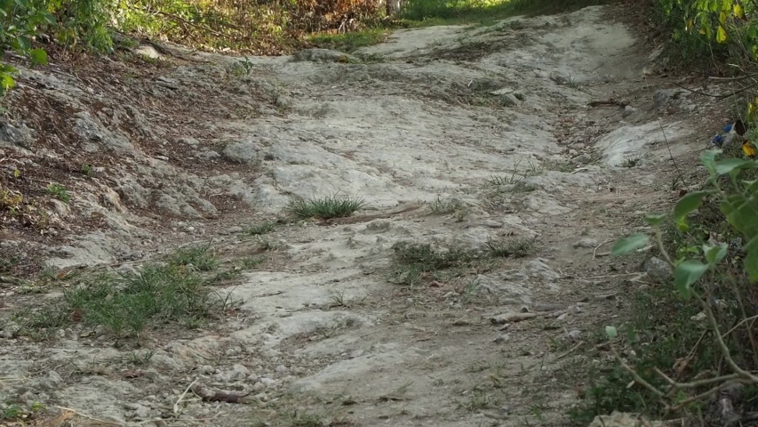 Low angle view. Mountain Bike Riding on Rocks. Outdoor activity.