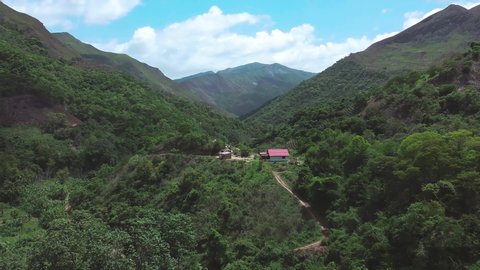 Daytime drone flight over isolated house located in a wooded area in Laguneta, in a group of mountains in the state of Miranda, Venezuela