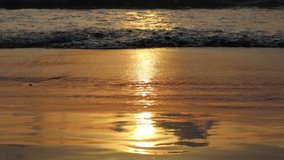 Light of sunset in the evening reflected on sandy beach.