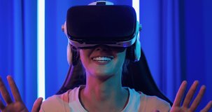 Portrait of young asian woman wearing vr for play video game. Gaming E-Sport concept.