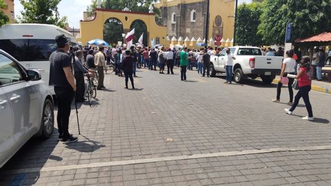 Cholula / Mexico - 06 17 2020: Moving Time Lapse of people gathering to see president of Mexico Andres Manuel Lopez Obrador during the Coronavirus pandemic in Cholula