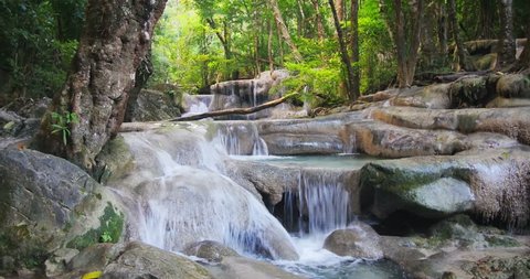 Beautiful nature of Thailand jungle rain forest with tropical plants and waterfalls of small mountain river running among stones and rocks