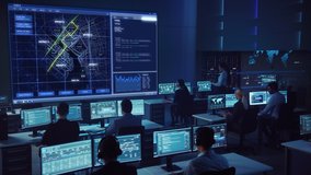 Team of Professional Computer Data Science Engineers Work on Desktops with Screens Showing Charts, Graphs, Infographics, Technical Neural Data and Statistics. Low Key Control and Monitoring Room. - Powered by Shutterstock - Get 15% off with code: PIKWIZARD15