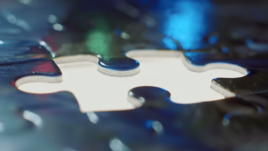 Install the last puzzle element to the place highlighted below. Macro. Closeup. Shallow depth of field. Slow motion. High speed camera