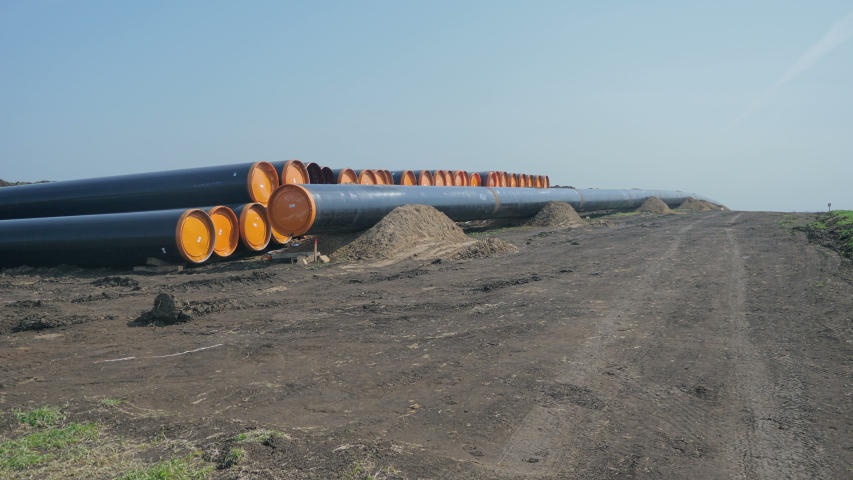 Natural gas pipe line. Pipes welded together, are laid on top of supportive sandbags beside the trench line. Turkish Balkanian Stream to Europe with Russian gas. Royalty-Free Stock Footage #1055511638