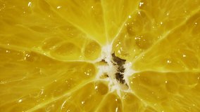 Macro view of orange slice. Rotative, abstract background. Extreme closeup of colorful juicy texture, structure of exotic fruit. Healthy food, citrus products for lemonade.