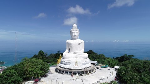Aerial view Drone camera video of White Marble Big Buddha Statue Temple on highest mountain Beautiful landmark in Phuket Thailand