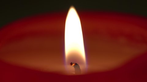A candle flame flutters in the breeze - macro detail