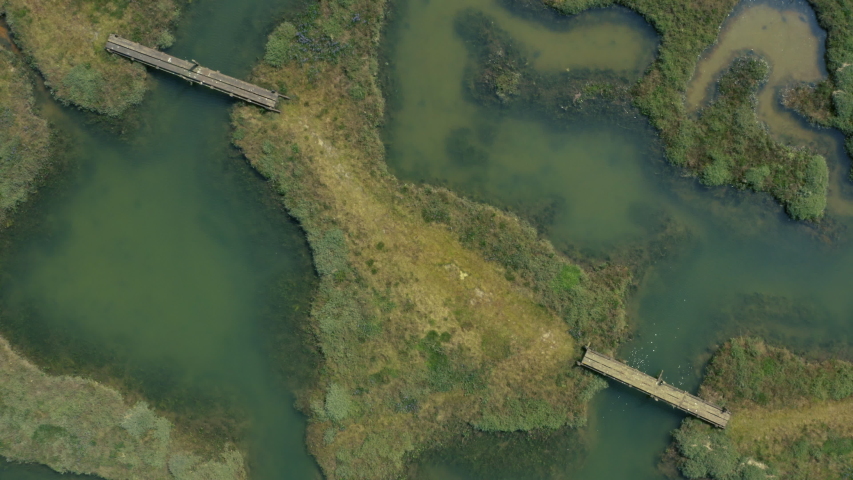 Aerial view of salt marsh path and bridges - zoom out shot 
