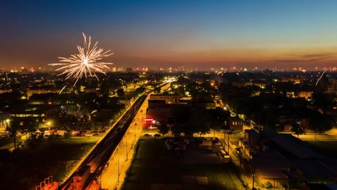 aerial drone hyper lapse of the city fireworks during 4th of July in Chicago west side neighborhood.  Independence day is a festive day that Americans celebration city wide