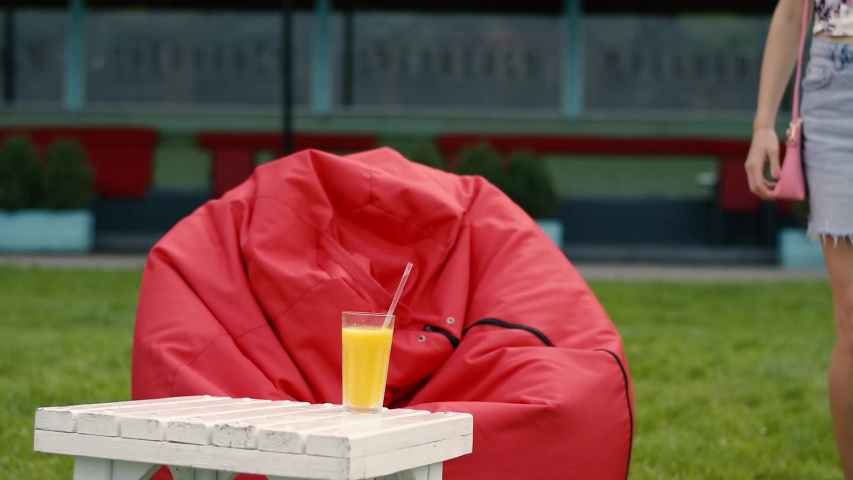 Beautiful girl drinks juice by the sea.Young woman in sunglasses drinks on the beach.beautiful summer girl having a cocktail drink.