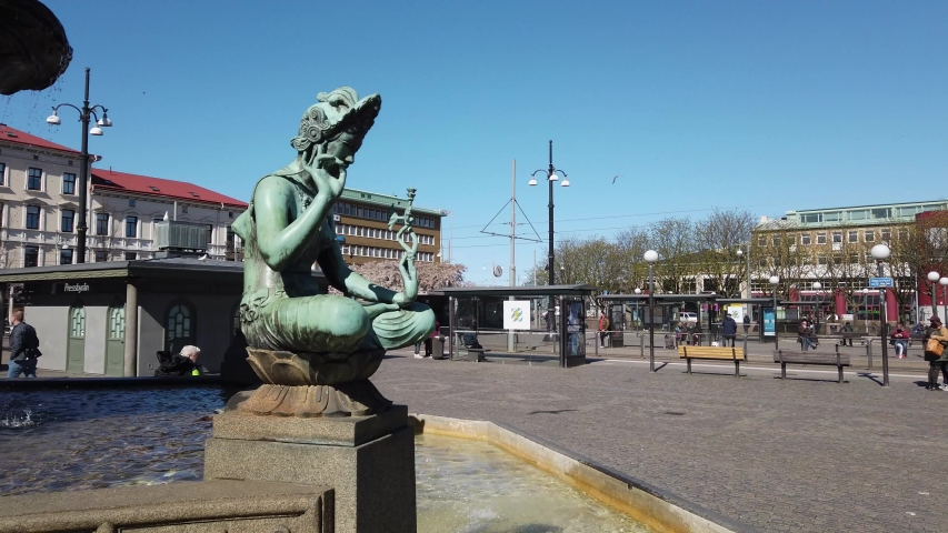 Fountain statue in Jarntorget on sunny day, Central Gothenburg. Pan left