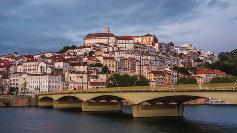 Coimbra, Portugal, zoom in timelapse view of Coimbra cityscape including historical landmark University of Coimbra and Mondego River at sunset.