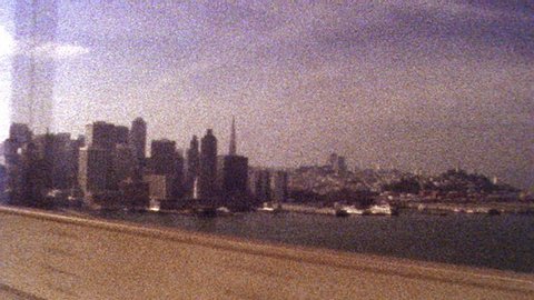 2019: Retro looking footage filmed on Super 8 old looking footage of San Francisco skyline while driving across Golden Gate Bridge