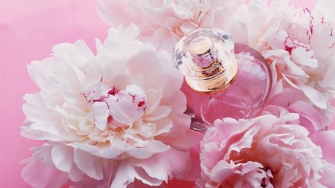Pink perfume bottle with peony flowers, chic fragrance scent as luxury cosmetic, fashion and beauty product backgrounds