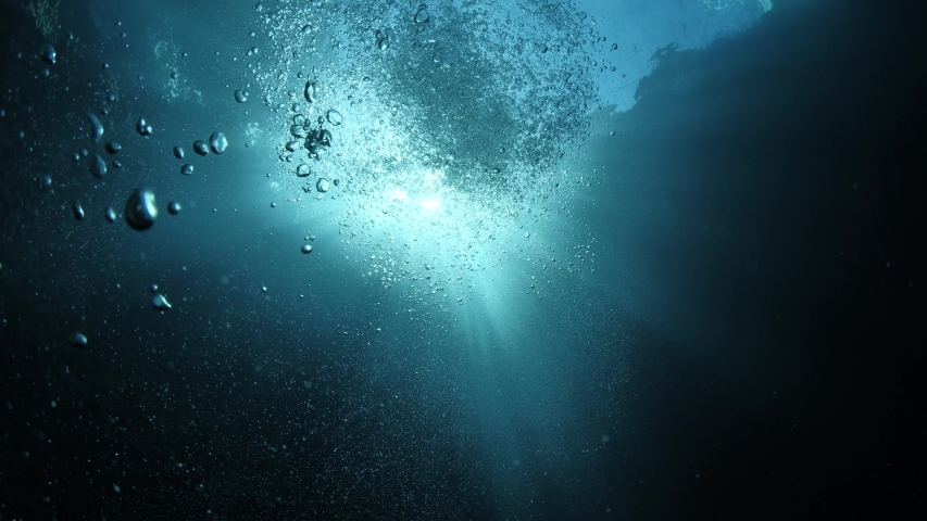  underwater close to surface with the sky view ocean scenery sun beams sun rays and air bubbles slow relaxing ocean backgrounds | Shutterstock HD Video #1055555102