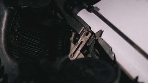 writer types on typewriter keyboard