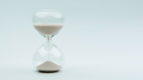 Modern hourglass with white background for copy space. Concept for business deadline, urgency and running out of time.