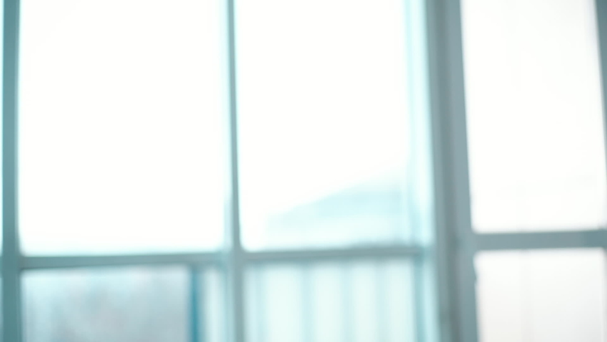 Close-up of good-looking young woman is putting hands in namaste posture and breathing relaxing her body and mind. Meditation, hatha yoga and people concept. Tracking shot in slow motion.