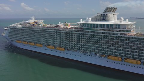Royal Caribbean Cruise ship, Miami, 2019. Gorgeous aerial view of beautiful white cruise ship heading to the open waters of Atlantic ocean. Relaxing voyage on the luxury vessel to the tropical island
