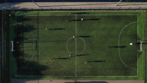 Top view of a Sports soccer field with people playing soccer.a small Football field on the street in the Serebryanka district.Belarus