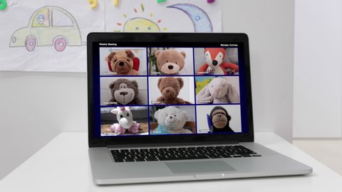 a group of teddy bears on a laptop screen for a virtual remote video chat