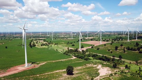 Aerial of Windmills for electric power production with white cloud and blue sky at Huai Bong, Dan Khun Thot district, Nakhon Ratchasima THAILAND. renewable energy and save  environmental concept