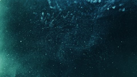 Glitter abstract background. Cosmic dust. Teal blue sparkling smoke hypnotic motion.