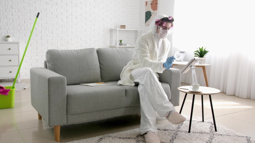 Housewife in protective costume resting at home
