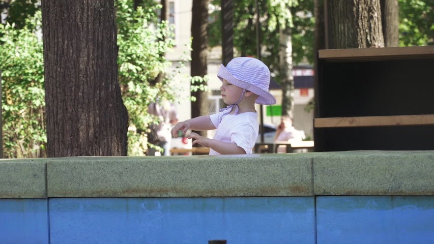 Boy near the fountain in the city park
