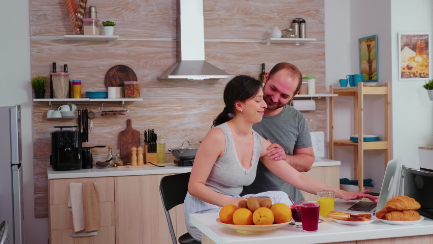Couple doing online shopping on laptop during breakfast. Entering information, customer using e-commerce technology buying stuff on the web, cosumerism banking and ordering